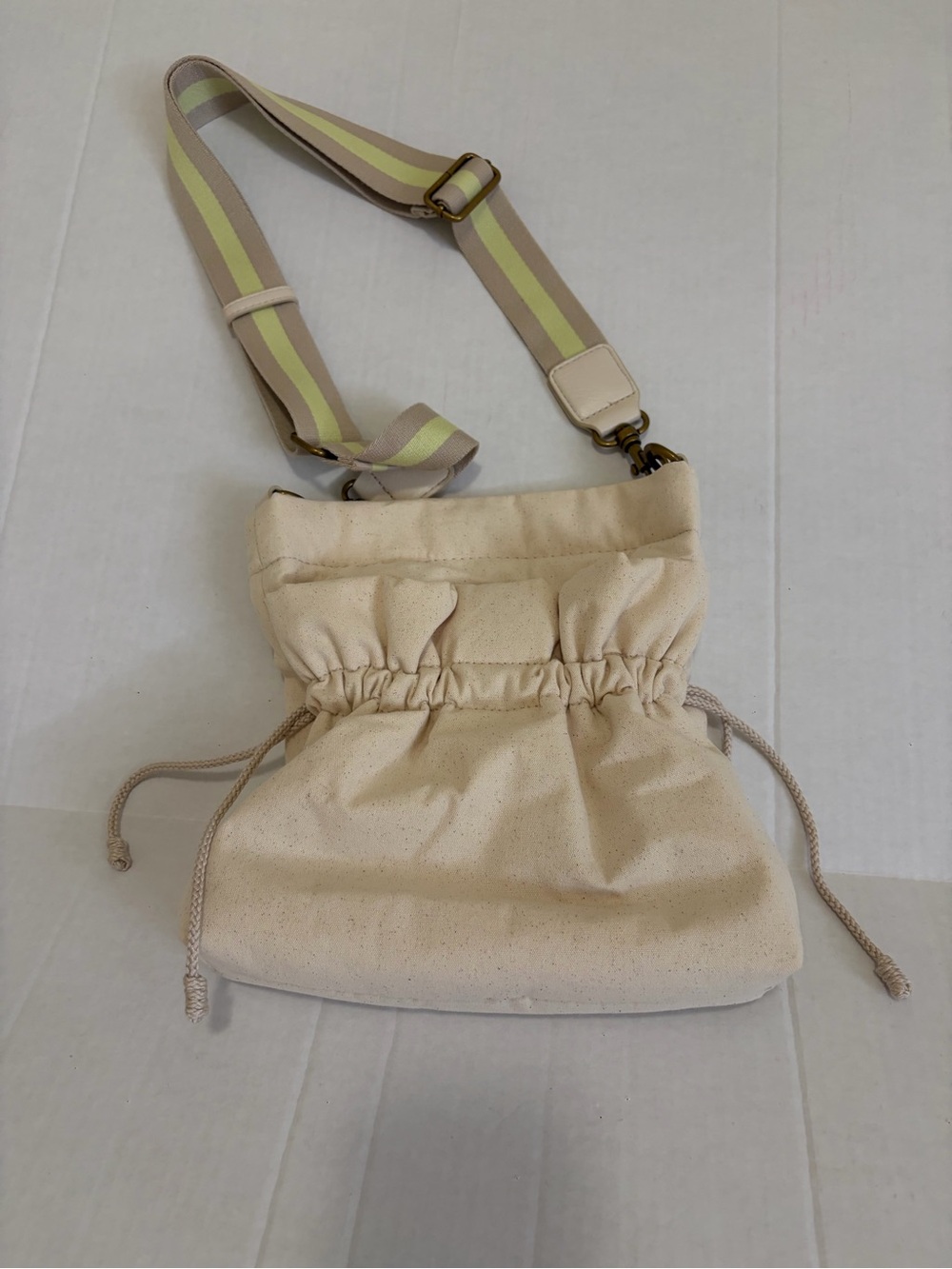 Women’s Neutral Drawstring Crossbody Bag with Striped Adjustable Strap